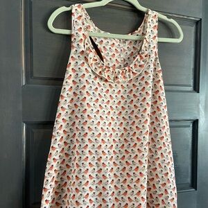 Women’s tank with ruffles on the back.